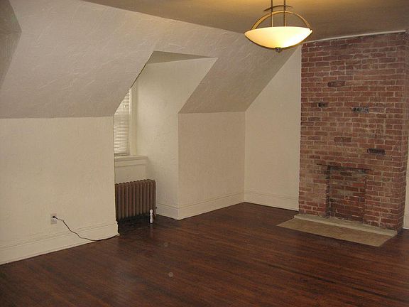 Your Living Room includes hardwood floors and a brick firepl