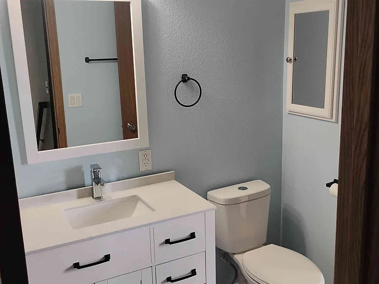 Main bathroom has new cabinets, sink, toilet, tile.