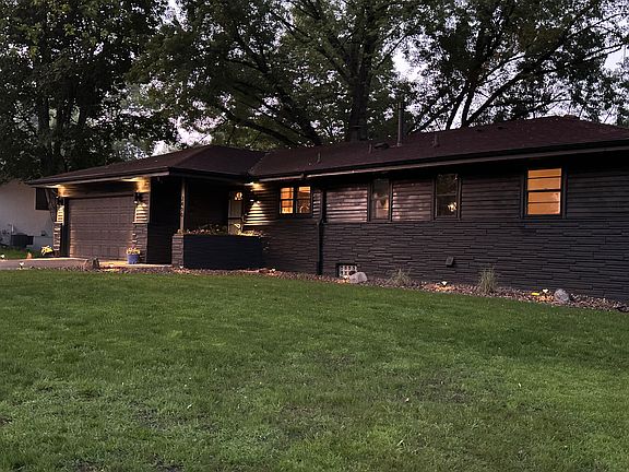Modern black exterior with warm lighting throughout perimeter.
