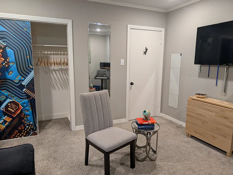 There is a drop-leaf table below the TV. 
This is one of two closets designated for this room.