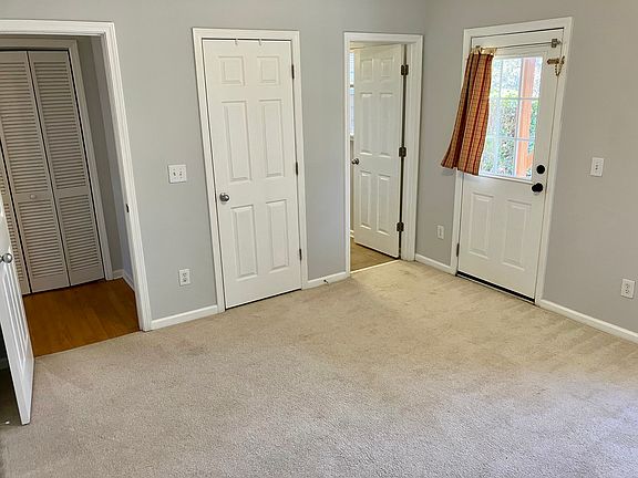 Downstairs bedroom with en suite bathroom and patio access.