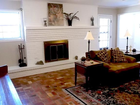 Den
						:
						Beautiful wood burning fireplace in this large comfortable den.