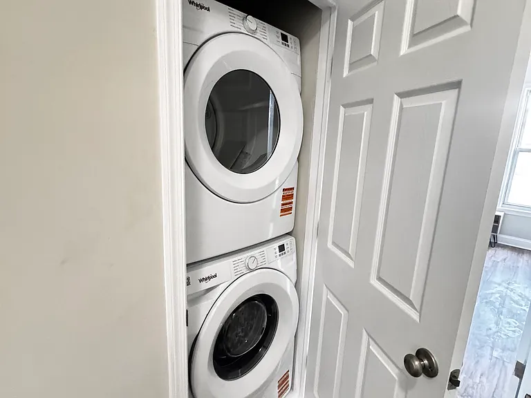 New washer/dryer on the first upper floor, accessible from the shared hallway