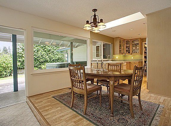 Dining room open to kitchen and family room with sliders to deck. Another beautiful window!