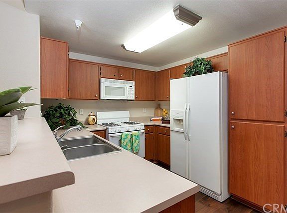 Appealing Kitchen with wood flooring, upgraded lighting.  Refrigerator, Stove, Microwave, & Dishwasher are included.