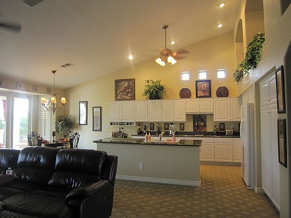 Family room into Kitchen, after new painting, hardware, and ceiling fans