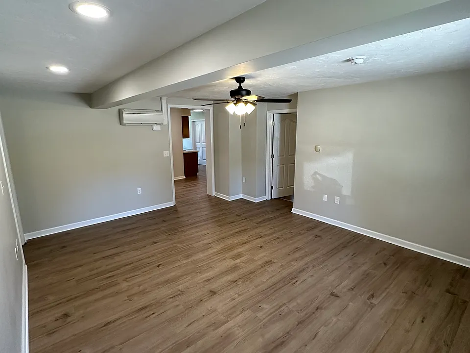 From the front door viewing the large living room. Ceiling fan with light.