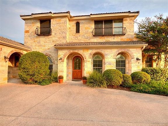 Elegant Tuscan style design with low-maintenance native limestone and lush landscaping.