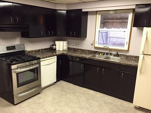Kitchen has newer stainless, 5-burner top gas range. Includes dishwasher disposal and refrigerator.