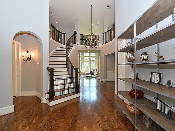 Grand entry with view throughout home and elegant iron wrought stair railings.
