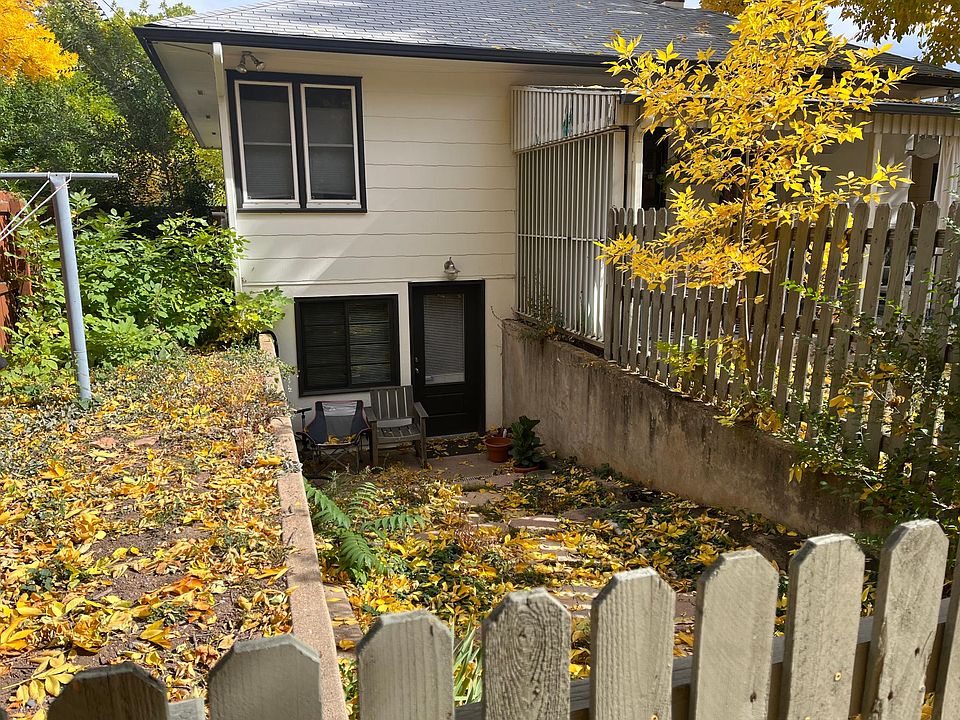 outdoor stone staircase path to entrance, behind gated wooden fence