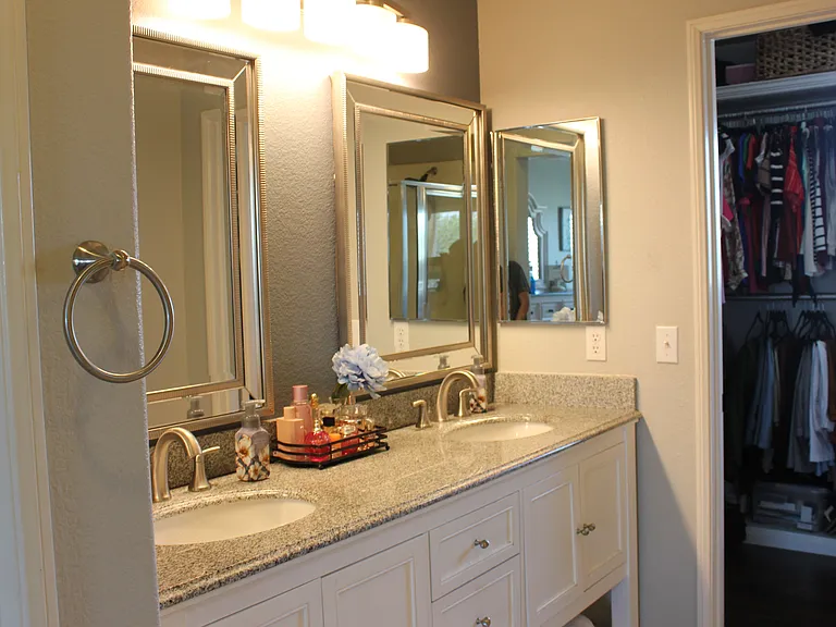 Large vanity with dual mirrors and granite countertops