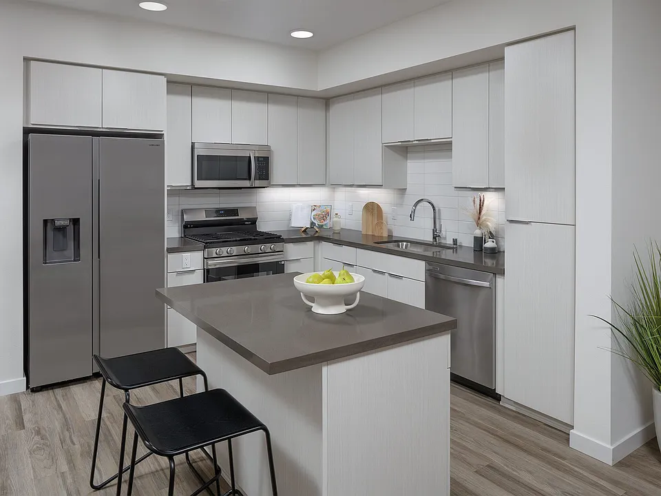 A generous island adds workspace and seating to the modern kitchen.