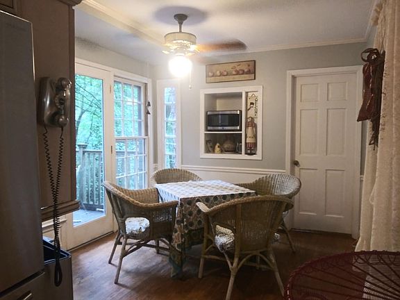 Eat-in area of kitchen with door to laundry and door thru bay window wall to open deck