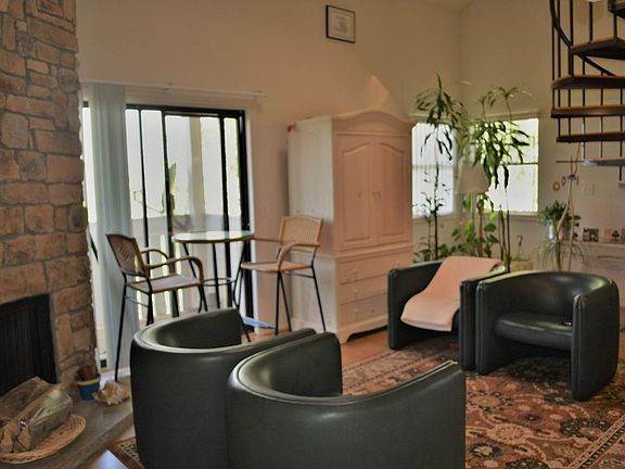 Large living room with rock feature fireplace.