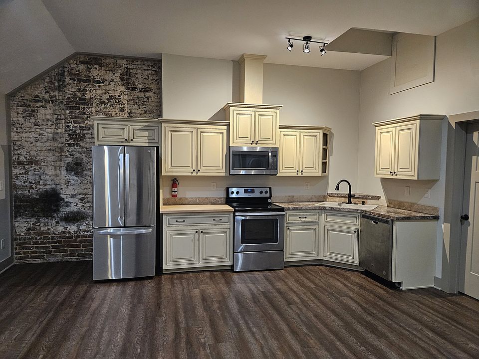 View of Kitchen With Custom Maple Ridge Cabinetry and all Stainless Steel Appliances. & Glass Top Electric Stove
