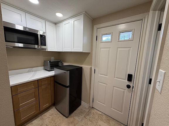 Entry door opens into kitchenette with first bathroom on the right