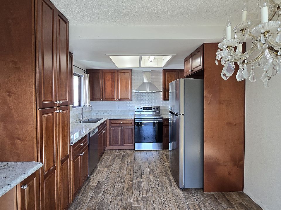 Kitchen This beautiful kitchen features stunning hardwood cabinets, offering ample storage space and a warm, inviting feel. The layout is both practical and stylish.