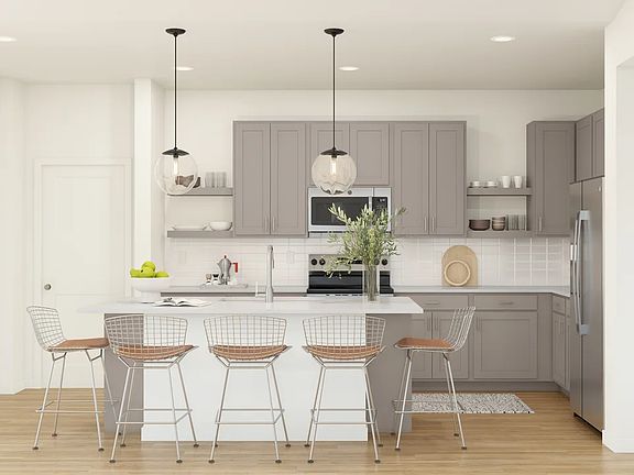 Kitchen with pendant lights vast island