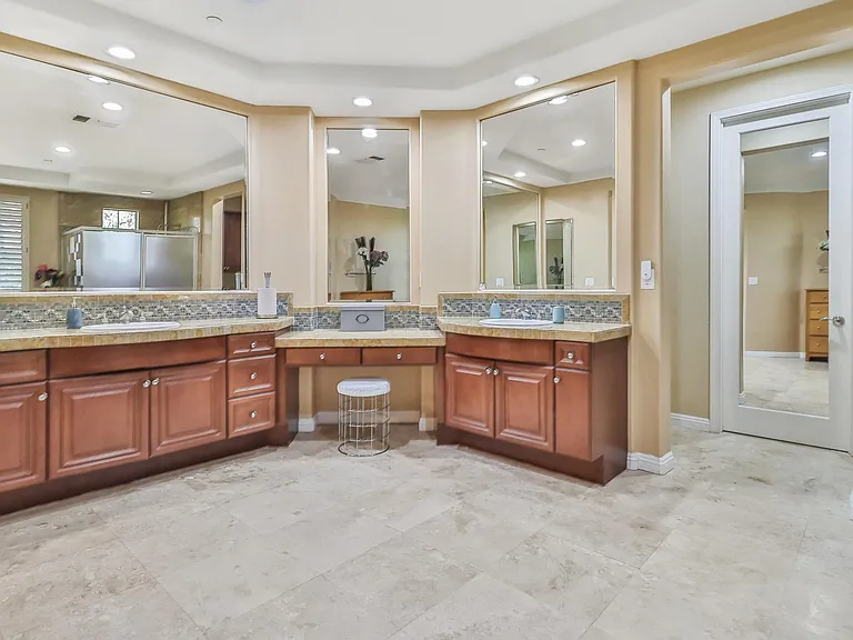Large Main Bathroom with separate sinks and a make up vanity.