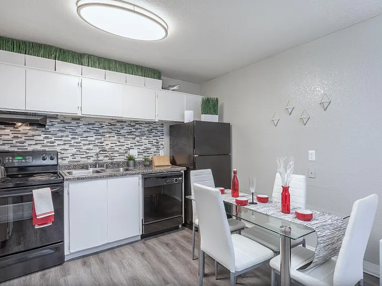 Contemporary kitchen with updated cabinets and black appliances