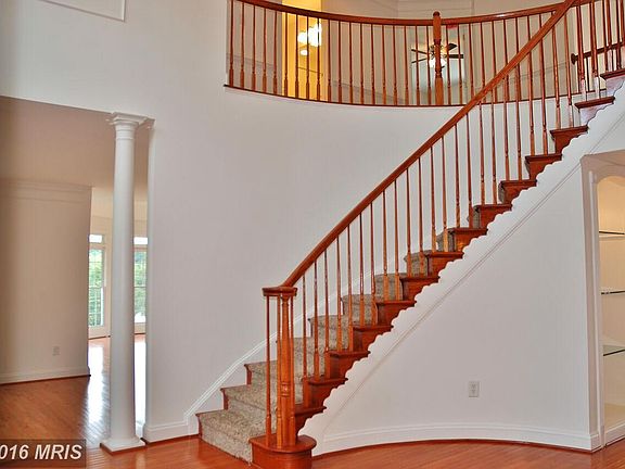 Two Story Foyer With Curved Staircase