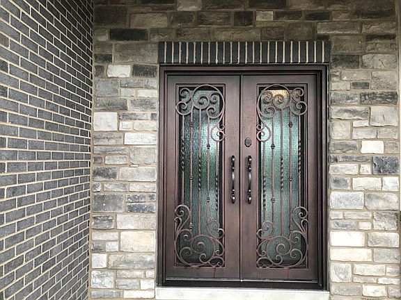 French double entry door with unique screened in glass that opens from the inside.