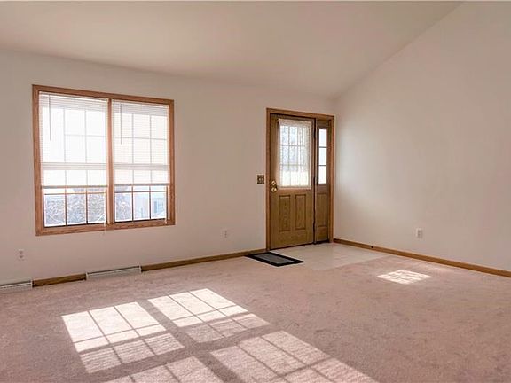 Living area featuring vaulted ceilings, new carpet and fresh paint!