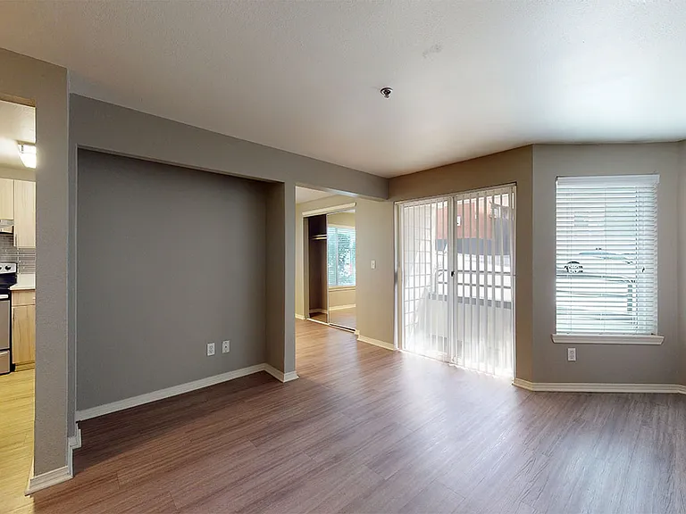 Apartment living room with wood-style flooring.