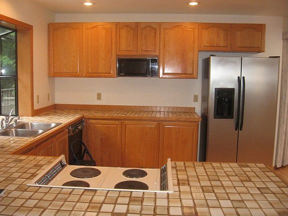 Large open Kitchen with Garden Window looking onto Greenbelt