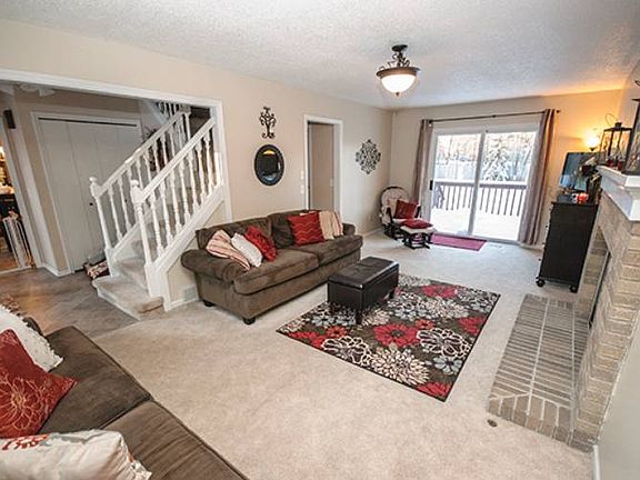 Open concept living room (11x23) features a beautiful gas fireplace with mantle and natural light fl