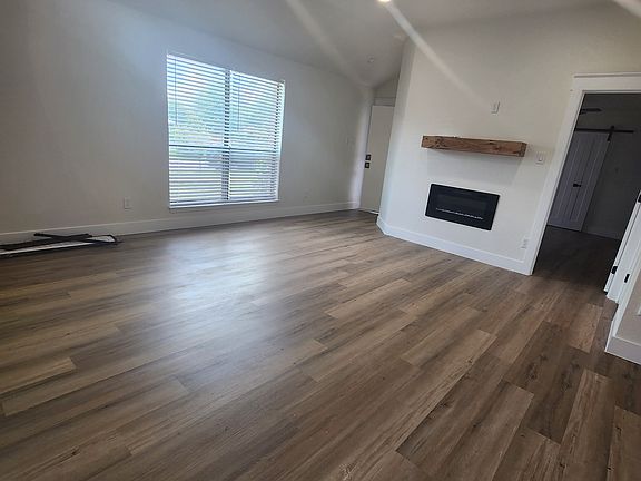 Living Room with electric fireplace and mantel. Master bedroom off living room