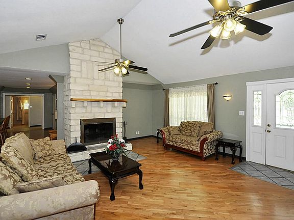 The floor to ceiling stone fireplace is the focal point of the den