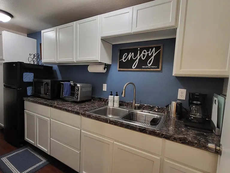 Basement Kitchenette has double sink and full size refrigerator. 
Microwave, toaster oven, and many appliances included.