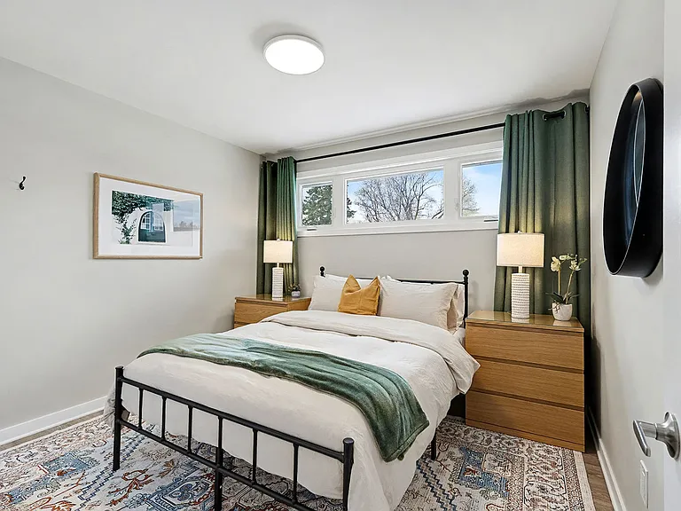 Relaxing main bedroom with a comfortable Queen mattress and natural light in our Ottawa furnished home.