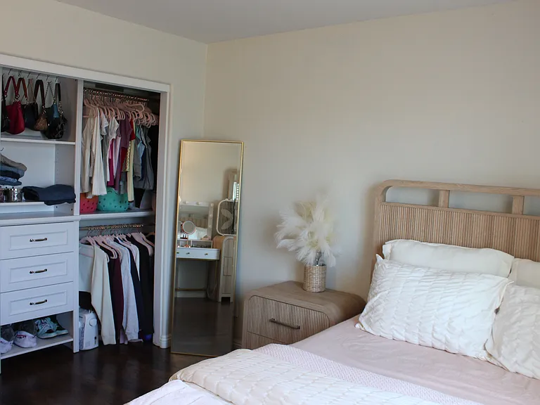 Bedroom with natural light and built in closet storage