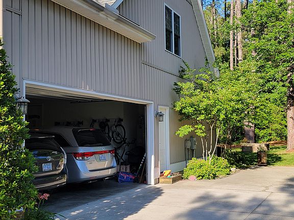 Two car attached garage opens to the mudroom with easy access to the downstairs laundry. There is also a parking pad that can park two cars side by side at the end of the driveway.