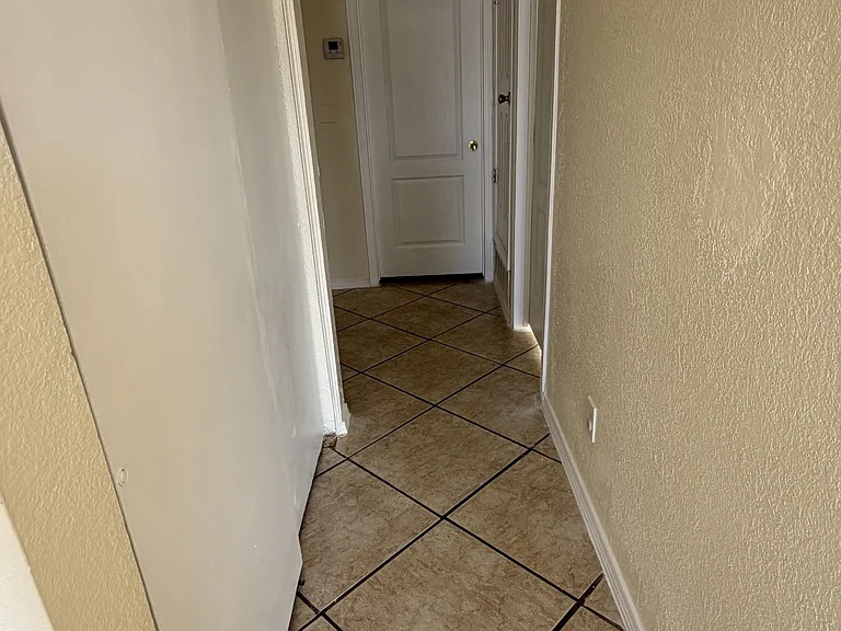 Washer and Dryer Hook ups behind left door in hall