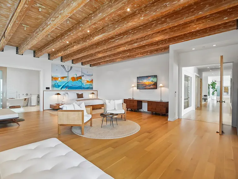 The primary bedroom boasts stunning ocean views through large windows.