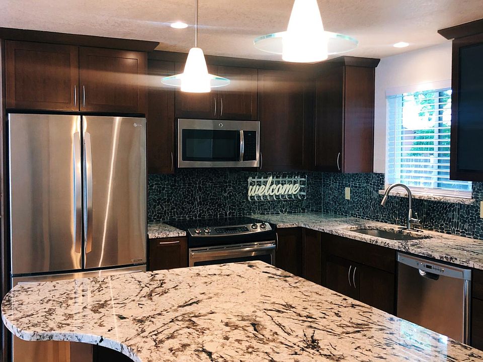 Custom granite - cabinets - wood floors- window over sink- stainless appliances