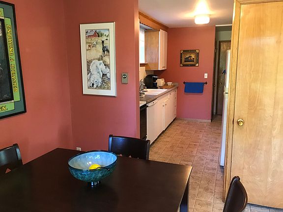 Galley kitchen has a door at both ends.