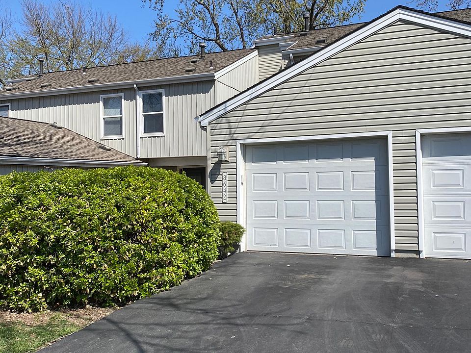 Outside with driveway and one-car garage