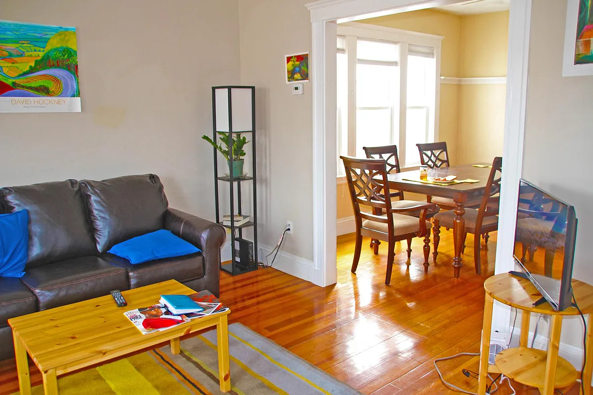Open plan living room (left) and dining room with 6 seat table. - Child St