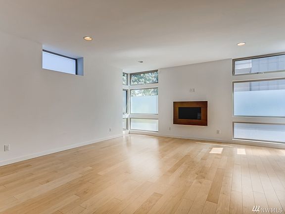 Full of bright natural light, this living space has an open airy feel and a warm fireplace. 