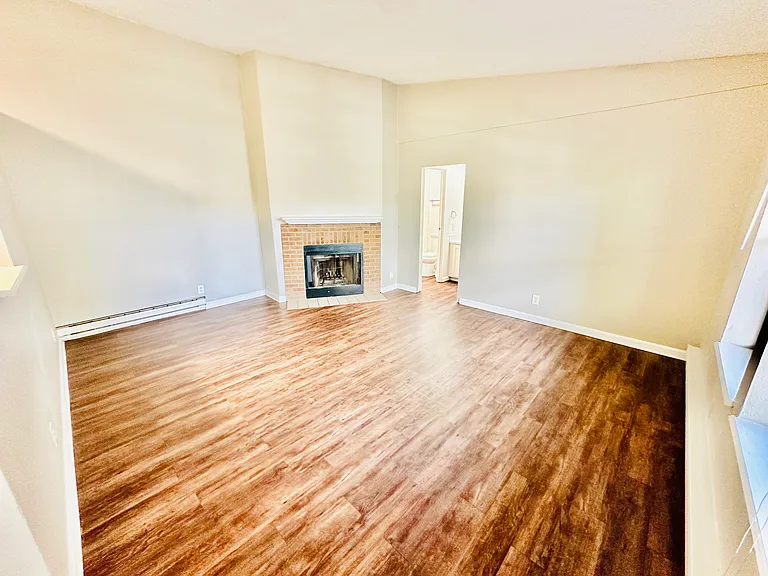 Relax in a beautifully designed living room with warm wood floors and a cozy fireplace. Relax in a beautifully designed living room with warm wood floors and a cozy fireplace.