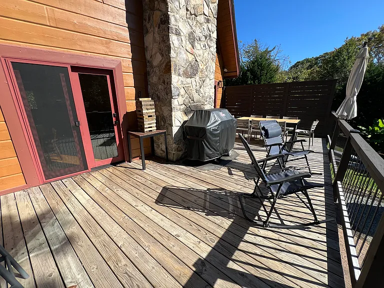 Upper deck off of the family room. Includes outdoor table, chairs, shade umbrellas and propane grill.