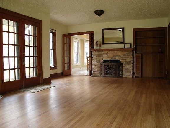 Original refinished wood floors and custom stone fireplace