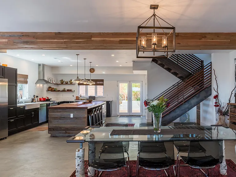 Large, open plan main level with reclaimed wood paneling and concrete floor.