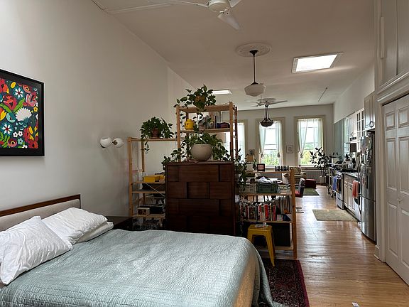 Loft sleeping area separated by bookshelves