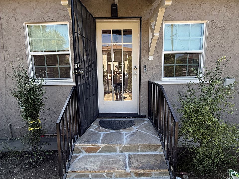 Main entrance to bungalow showing vintage wood and glass door